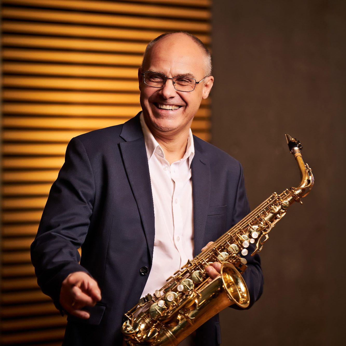 Eugen Wall, Musiker des Ensembles Clarissi.co hält ein Saxofon.